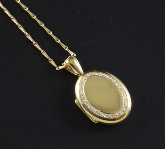 A 1990s Mappin & Webb 18ct gold and diamond oval locket on an 18ct gold chain, locket 1.25in inc. bale.